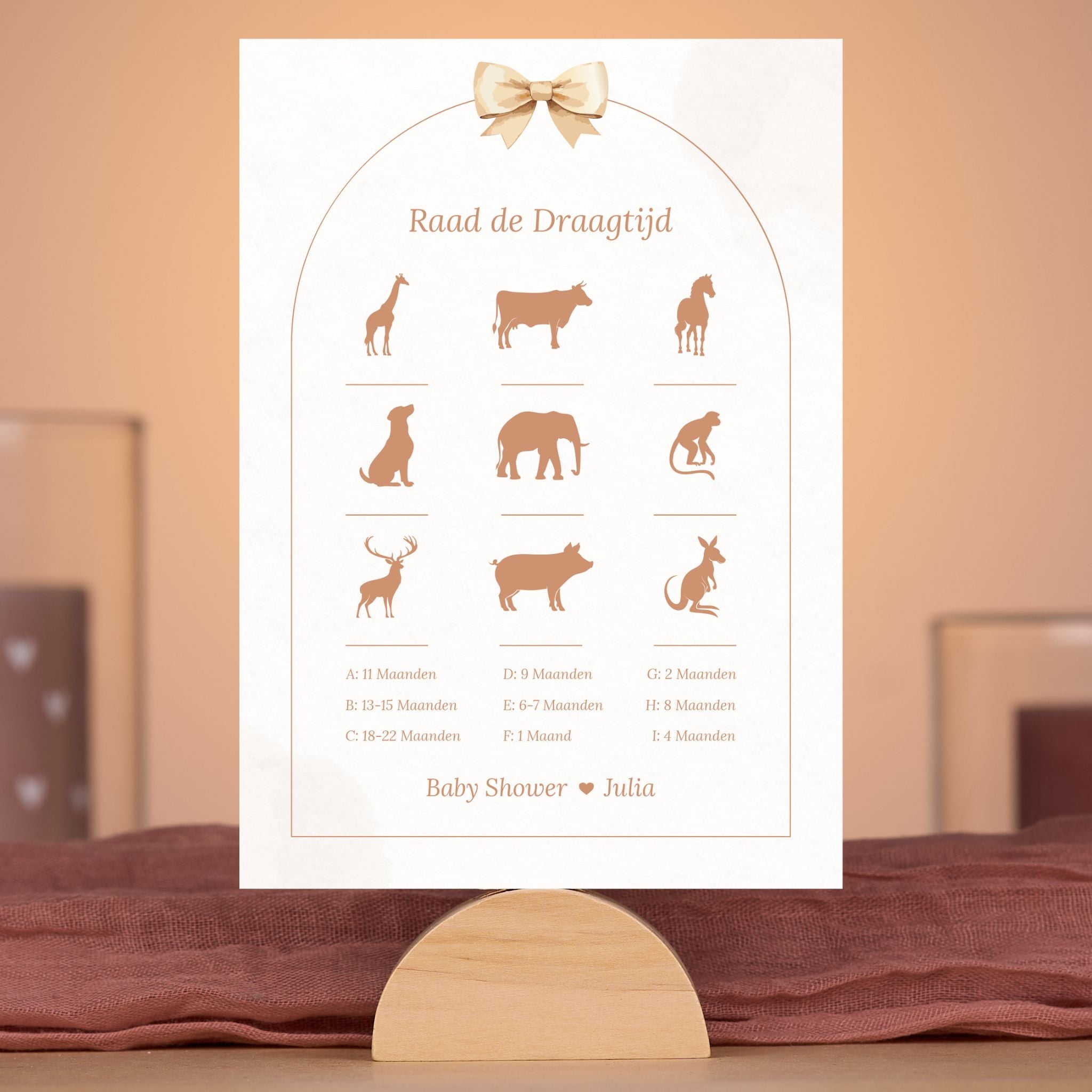 Boho babyshower spelkaart Raad de draagtijd met beige tinten en strik, gepersonaliseerd met naam – sfeervolle setting – Studio Miron